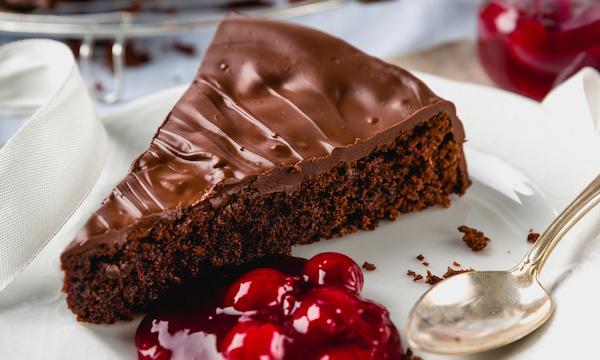 chocolate cake with cherries and golden spoon